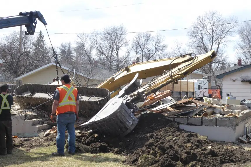 Excavator ends up in basement of home being destroyed