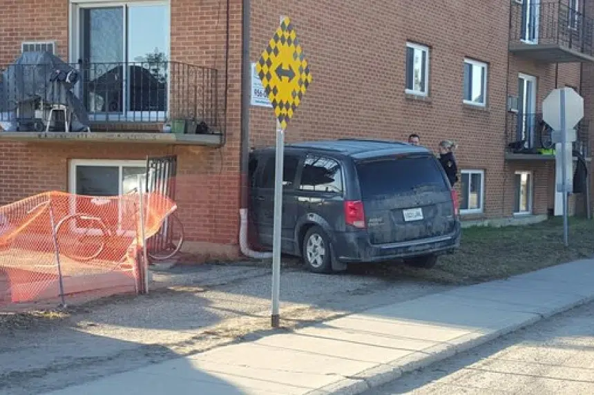 Update: Man arrested after minivan crashes into apartment building
