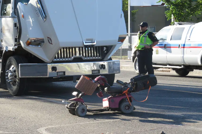 Woman killed after collision between gravel truck, scooter