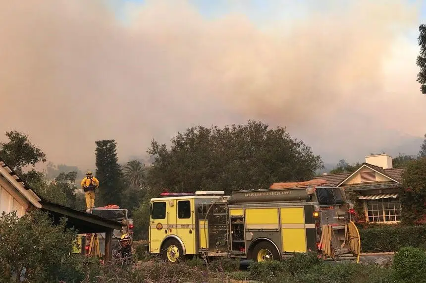 Flames threaten rich California enclave, residents flee