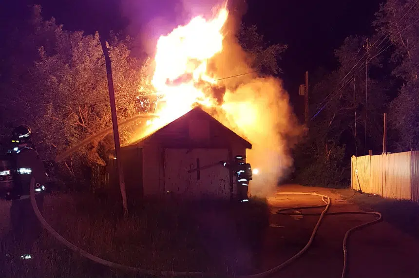 Early morning fire destroys garage, downs power line on Ave S