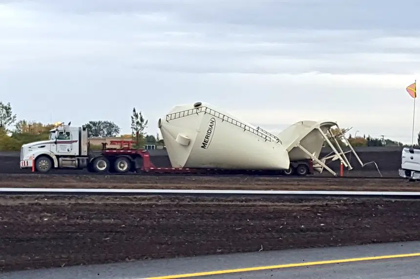 Truck hauling grain bin hits new overpass near Martensville