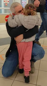 Abdullah Algherbawi embraces his daughter.