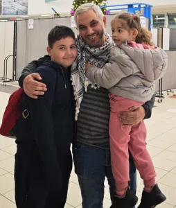 Abdullah Algherbawi holds two of his children after their reunion.