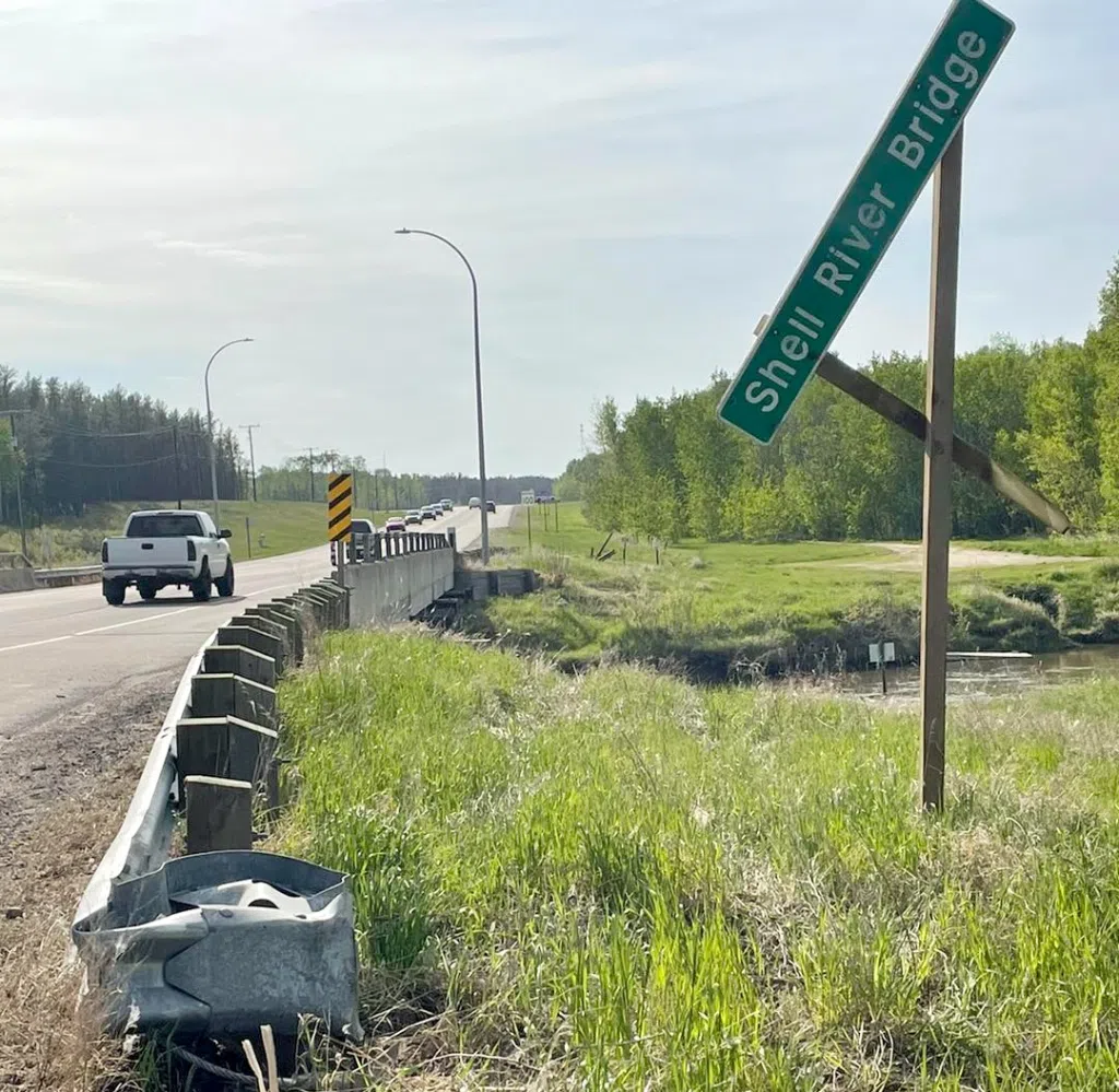 A damaged sign and guardrail at the Shell River following a crash.