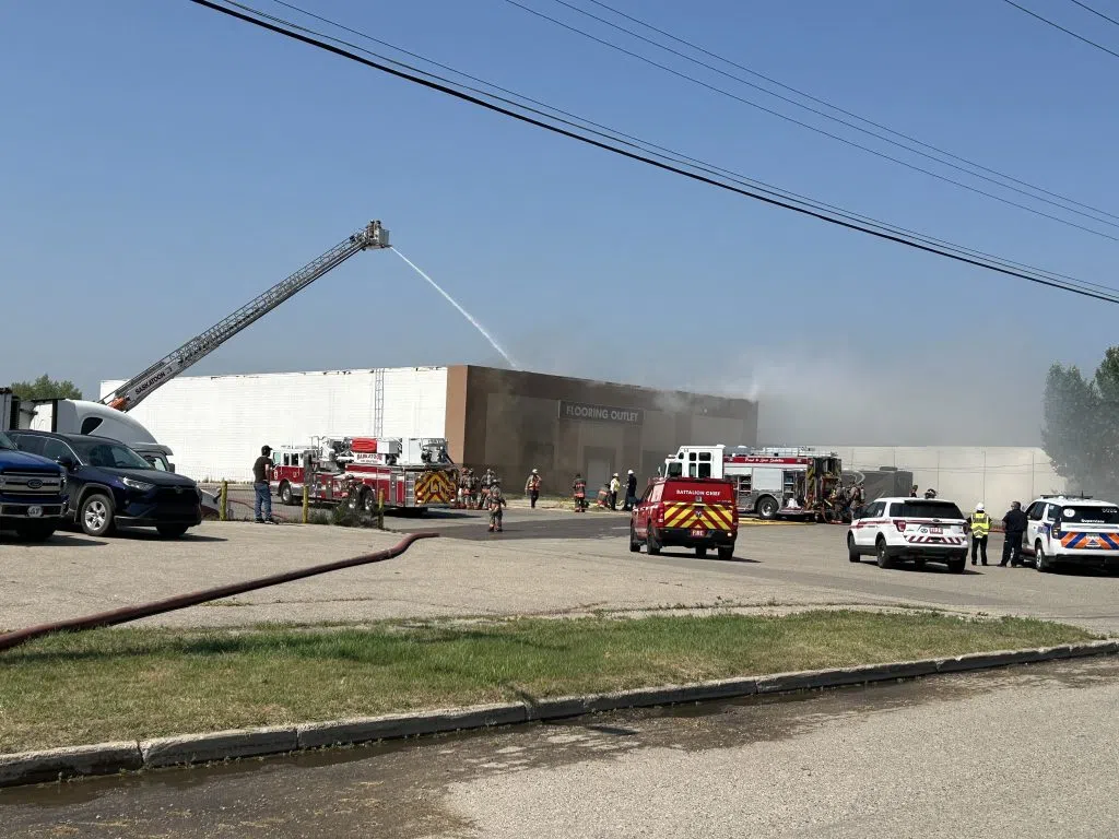 Saskatoon fire crews battle a blaze that broke out at Prestige Flooring on Jasper Avenue near Circle Drive on Wed., July 24