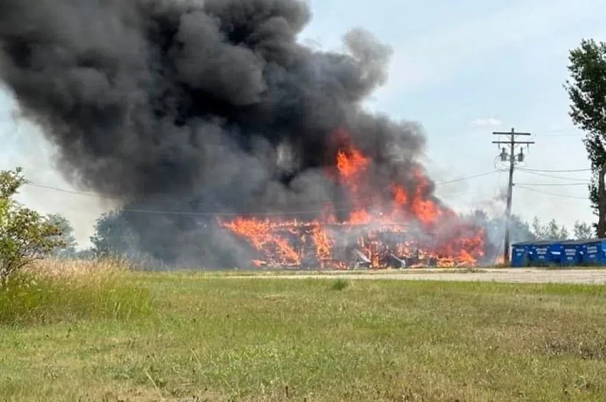 Submitted photos show a huge cloud of smoke engulfing the old school in Plunkett, Sask. (Mike Pastor/Submitted)