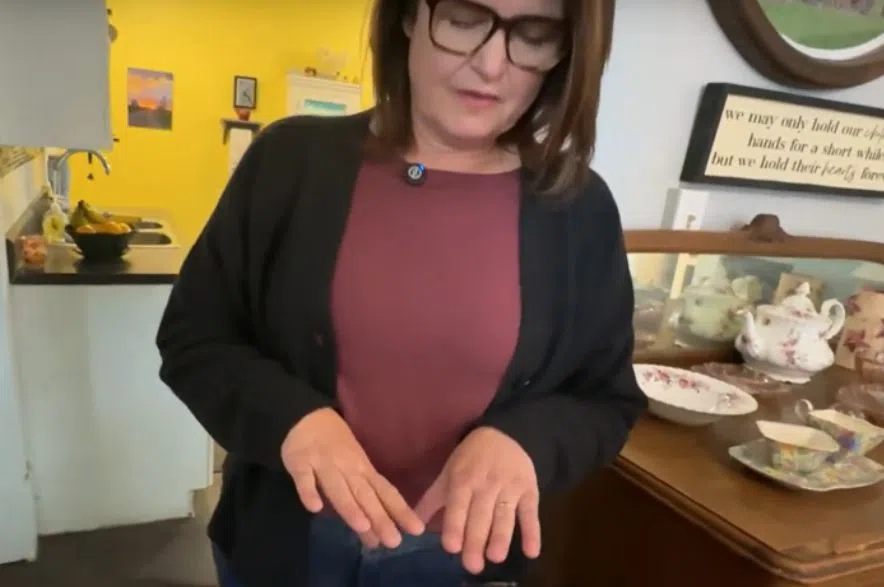 Carla Beck points to her unmanicured hands