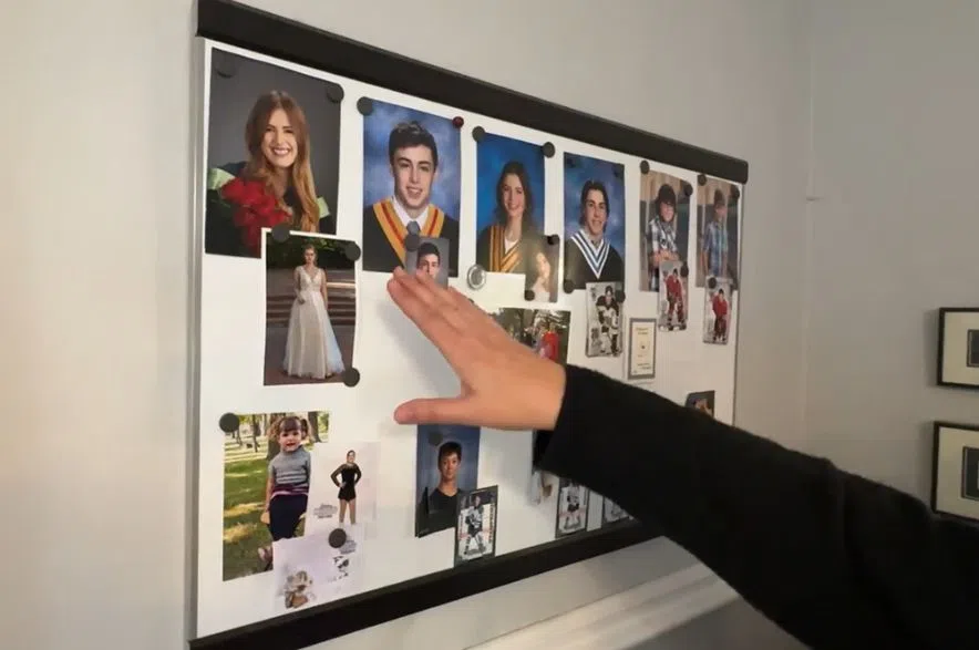 NDP Leader Carla Beck points to photos of her kids