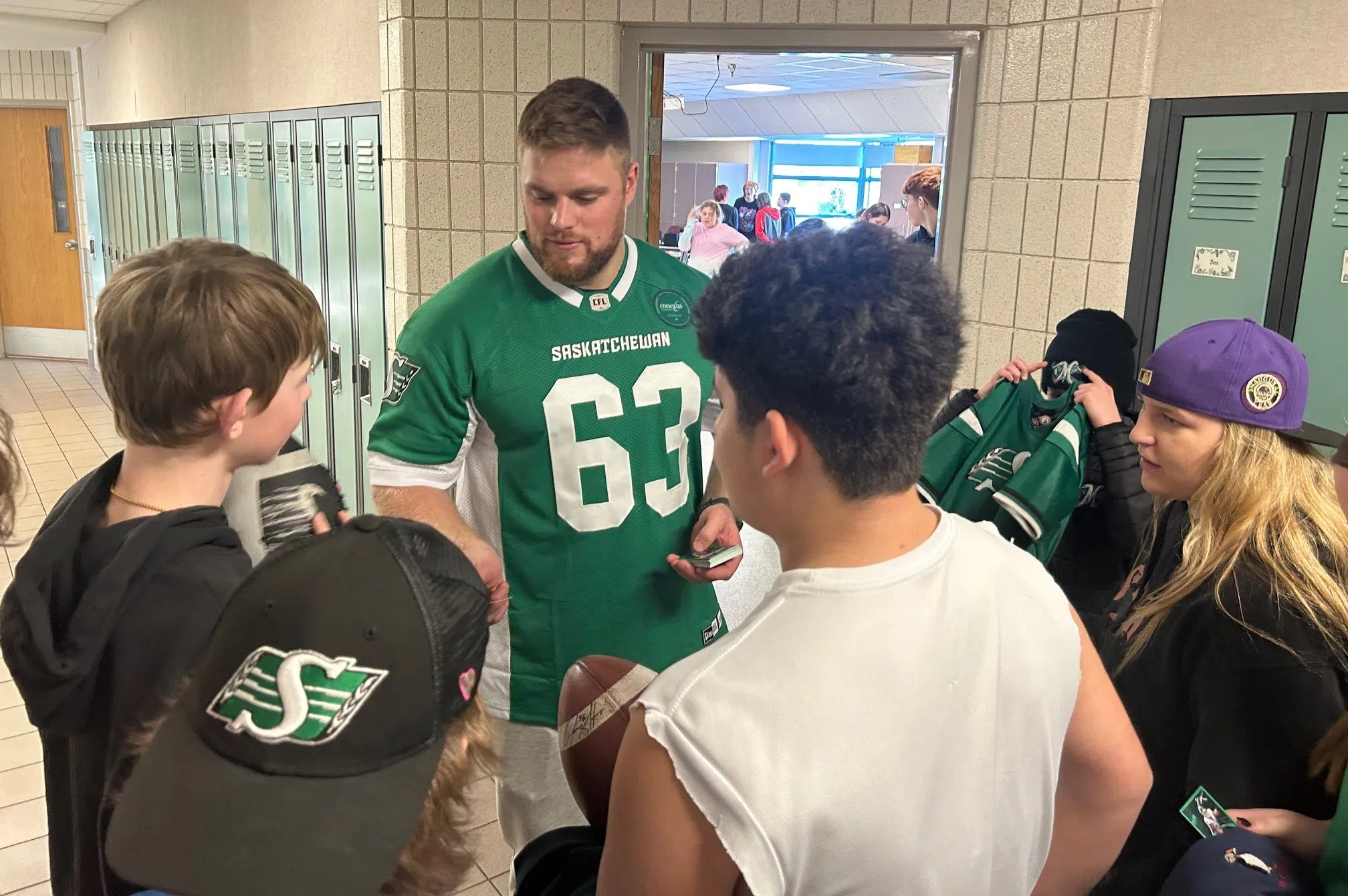 Logan meets with kids in hallway
