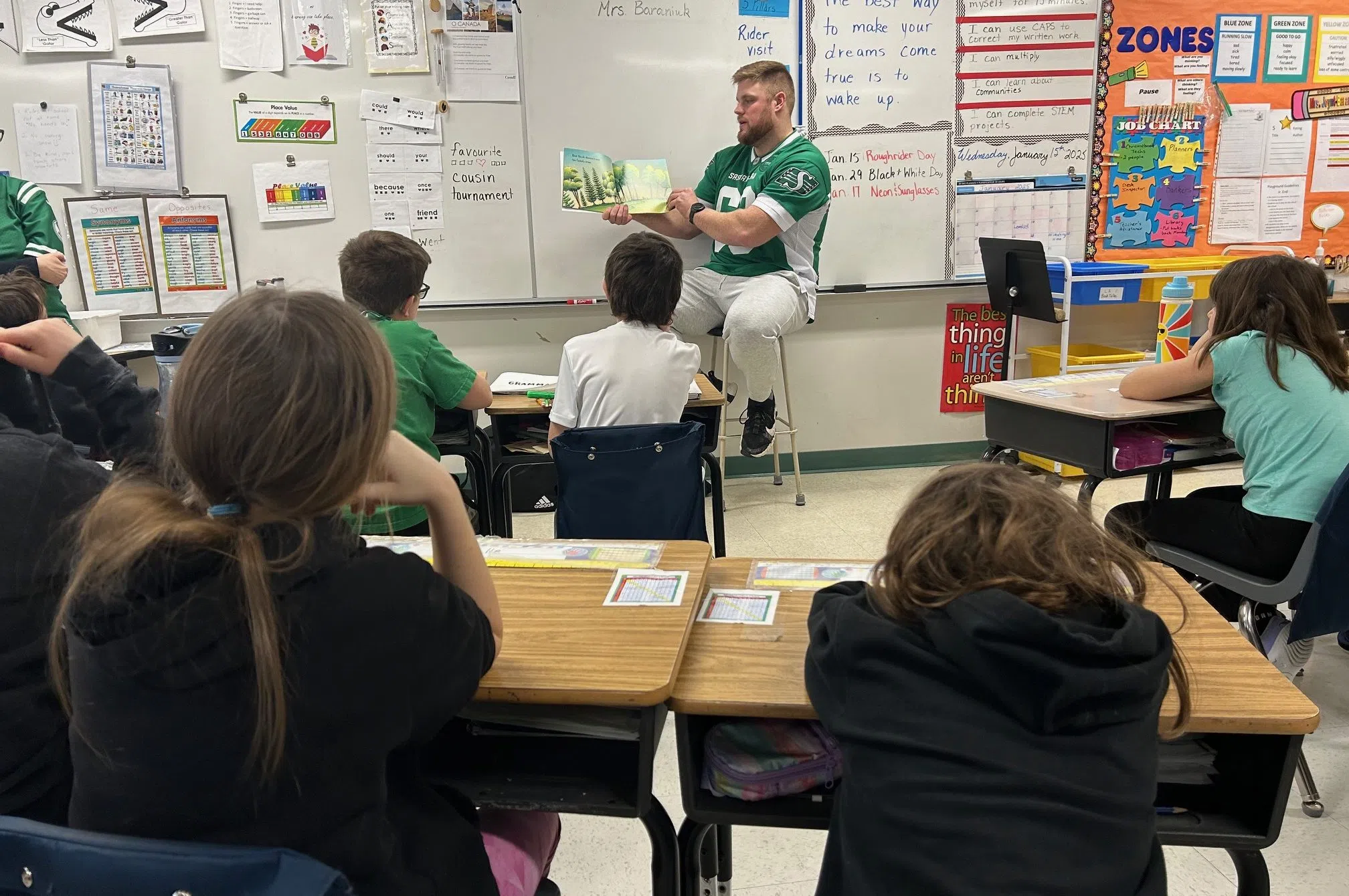 Logan reads to 3-4 class