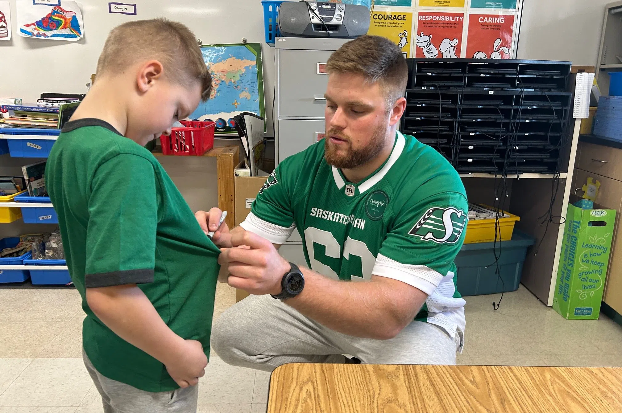 Logan signs shirt