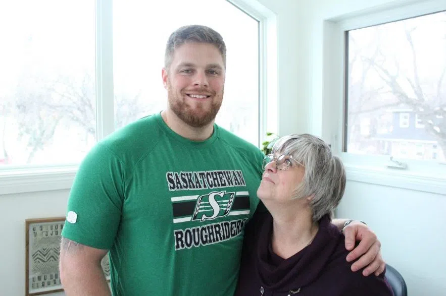 Logan Ferland stands next to his mother Cathy White Ferland