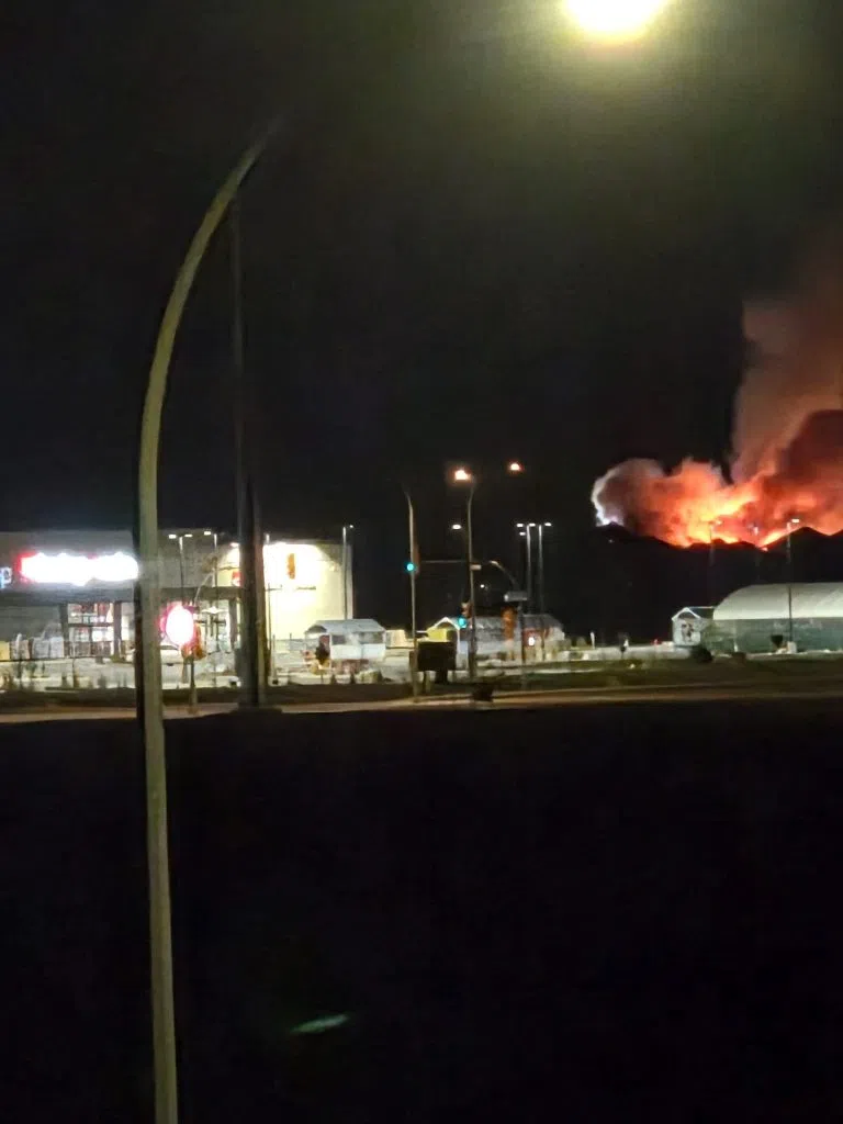 A Reddit user posted a photo of the double house fire that was taking place just behind the Evergreen Independence store. (kisshimnow/Reddit)