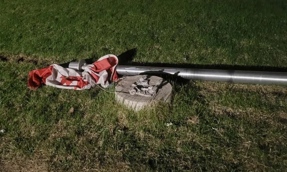 W.P. Bates Community School flag was lying on the grass while a truck had rammed into the school. (Amanda Walter/ Submitted)