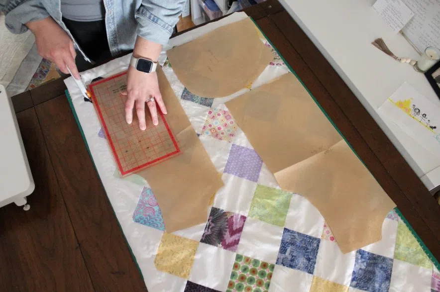 Ashleigh Hemsley cuts out a pattern from a quilt