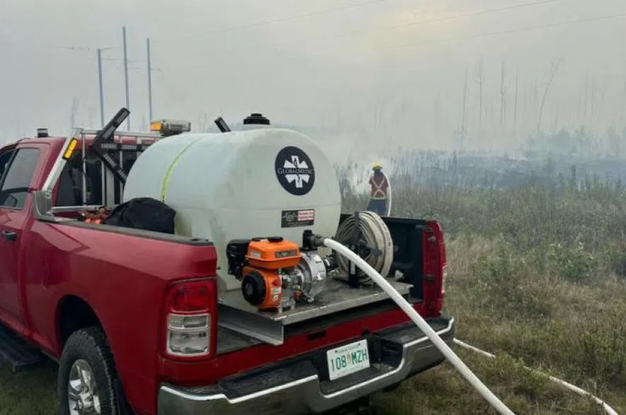 A member of Buckland Fire and Rescue using a wildfire skid unit to action one of the many blazes burning in northern Saskatchewan. (Buckland Fire and Rescue/Facebook)