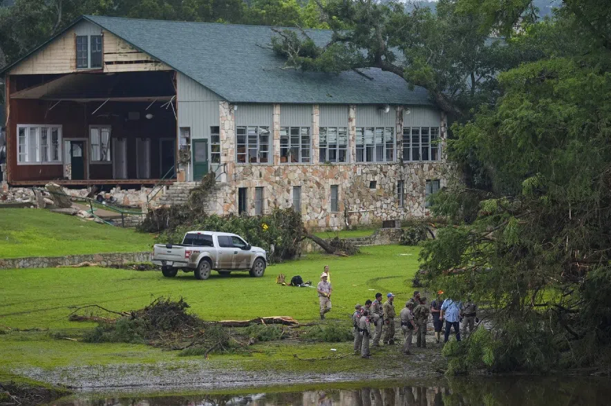 Officials search on the grounds of Camp Mystic.