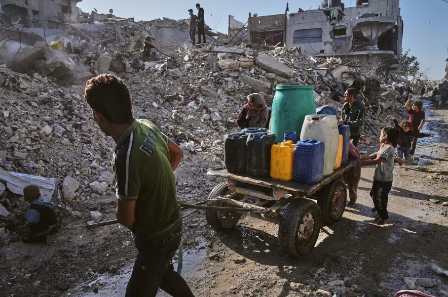 Palestinians carry water in Gaza.