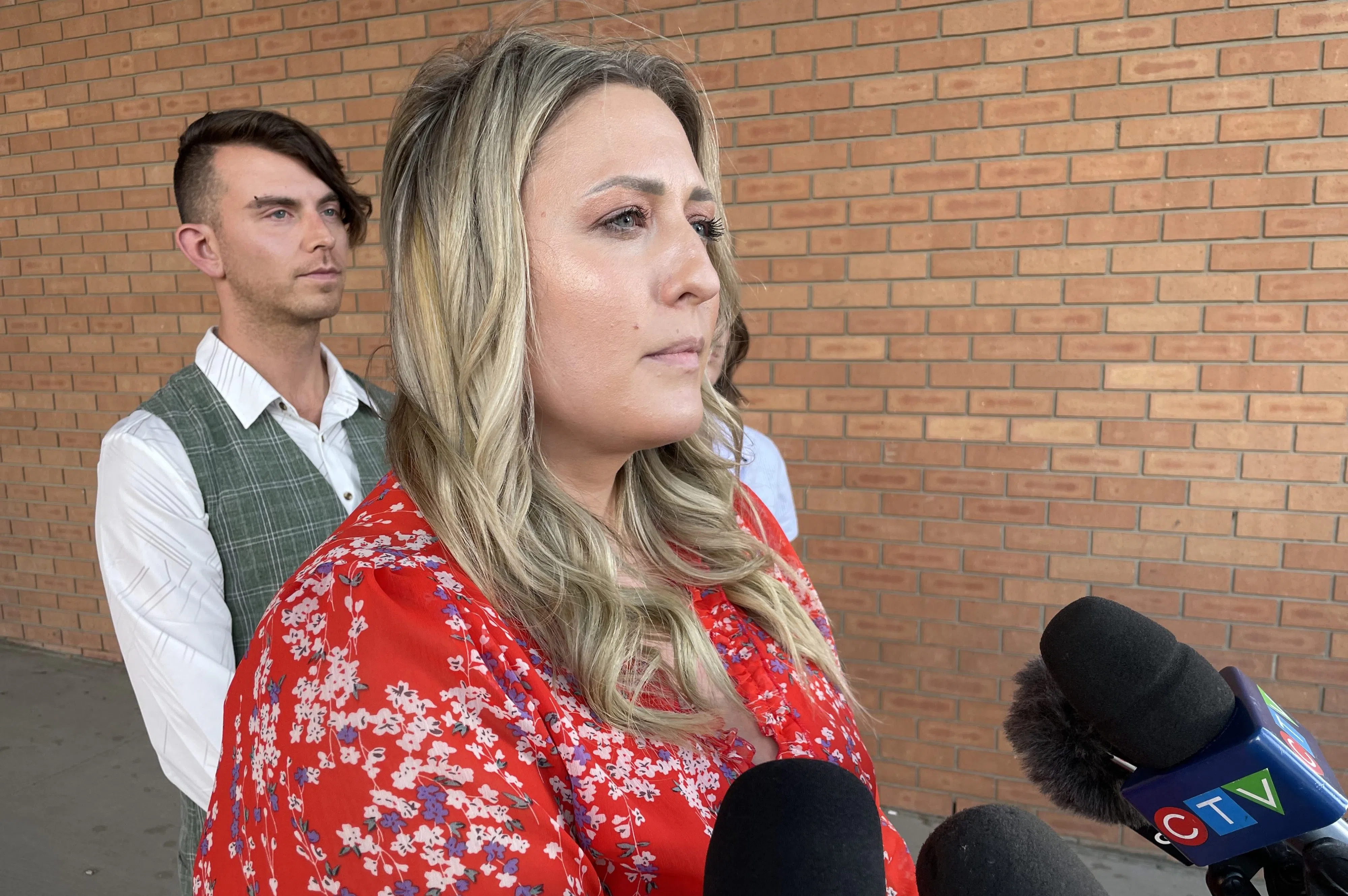 Caitlin Erickson in scrum in front of Saskatoon Provincial Court