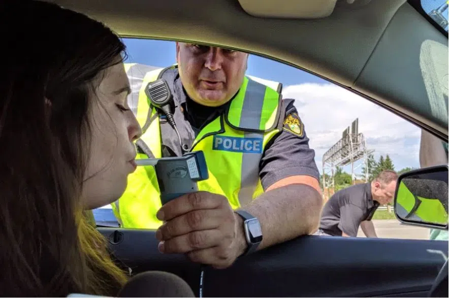 Police officer gives woman driver a breathalyzer test