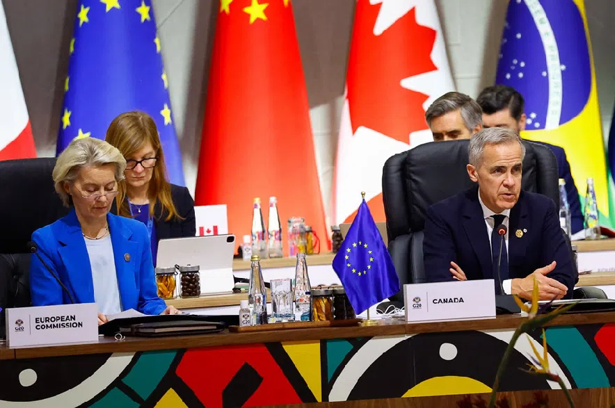 European Commission President Ursula von der Leyen and Prime Minister Mark Carney attend a plenary session on the opening day of the G20 Summit at the Nasrec Expo Centre in Johannesburg, South Africa on Saturday, Nov. 22, 2025.