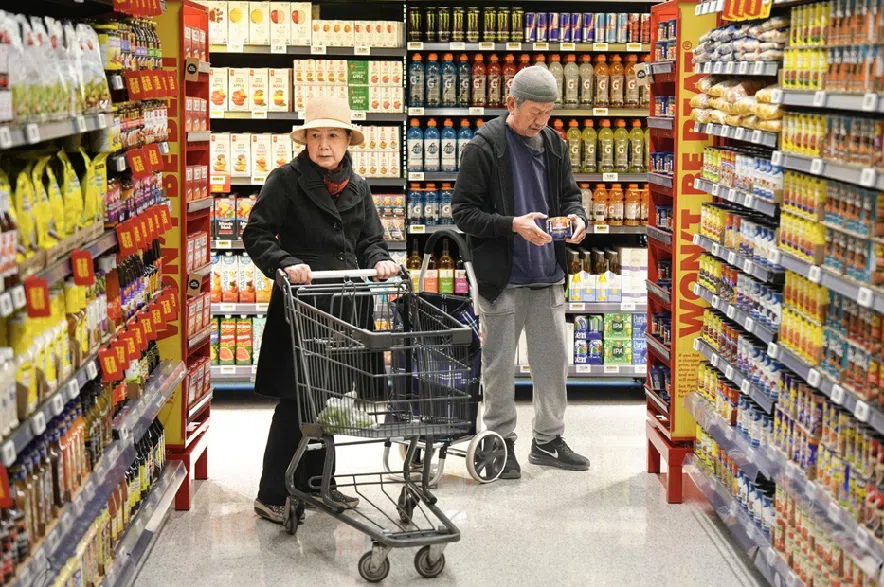 Customers shop in a new small format No Frills grocery store that the grocery chain is testing, in Toronto, Thursday, May 30, 2024.