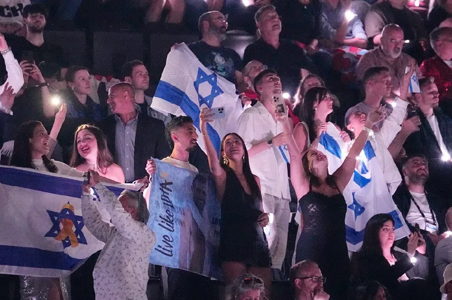 Israeli fans cheer for Yuval Raphael, from Israel, after she performed during the semi-final of the 69th Eurovision Song Contest in Basel, Switzerland, May 15, 2025.