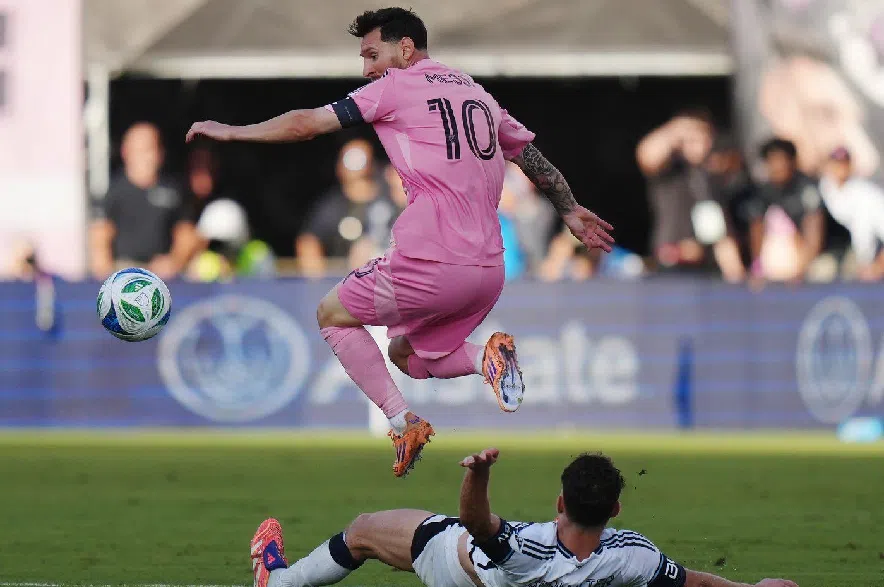 Inter Miami's Lionel Messi (10) leaps over Vancouver Whitecaps' Sebastian Berhalter (16) during the second half of the MLS Cup final soccer match, in Fort Lauderdale, Fla., on Saturday, Dec. 6, 2025.