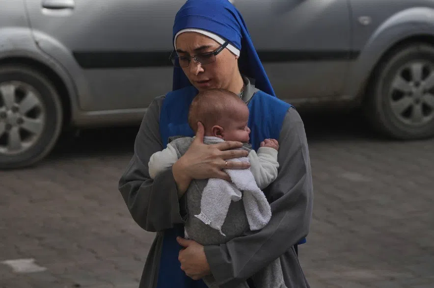 A nun holds a baby.