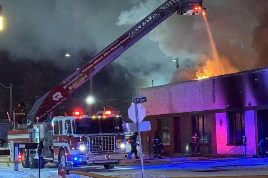 Prince Albert Salvation Army fire with firefighter truck and water being dosed from ladder above building