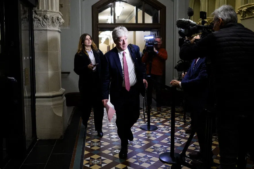 Minister of Energy and Natural Resources Tim Hodgson walks past reporters ahead of a cabinet meeting on Parliament Hill in Ottawa on Thursday, Dec. 11, 2025.