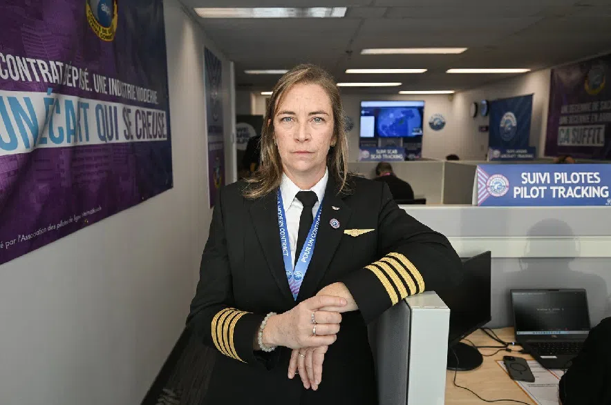 Air Transat Pilot and Air Line Pilots Association (ALPA) member Capt. Bibianne Lavallée poses at the Air Transat Pilot Strike Centre in Montreal, Wednesday, Dec. 3, 2025, following a 99 per cent vote in favour of a strike mandate.