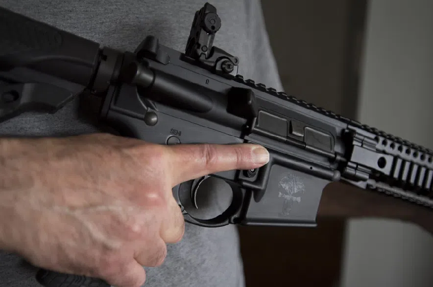 A restricted gun licence holder holds a AR-15 at his home in Langley, B.C., Friday, May 1, 2020.