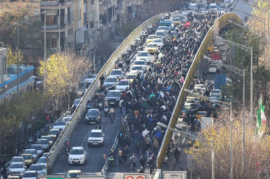 Protesters march on a bridge in Tehran, Iran, on Dec. 29, 2025.
