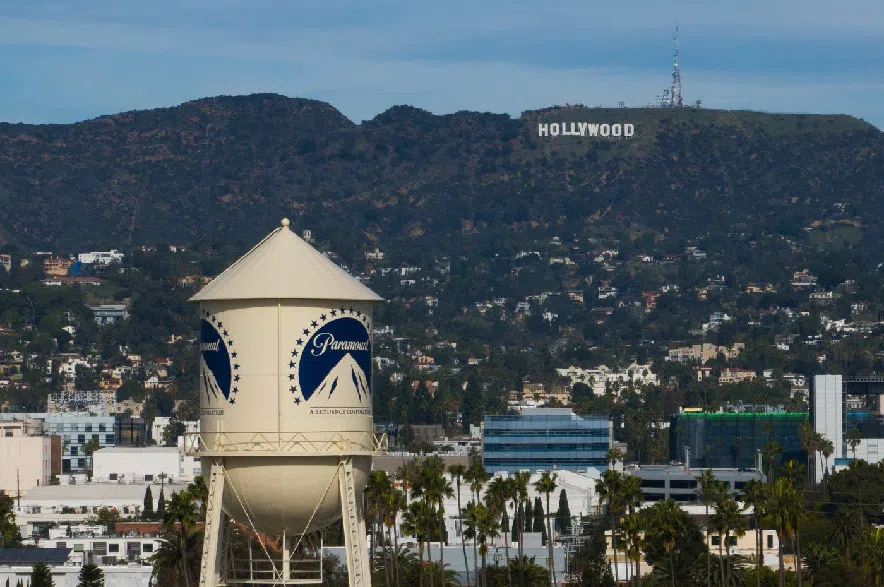 The Paramount Pictures water tower is seen in Los Angeles, Thursday, Dec. 18, 2025, with the Hollywood sign in the distance.