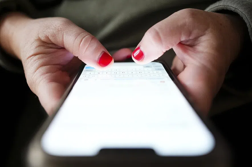 A person types on a cellphone in Ottawa on, Dec. 15, 2025.