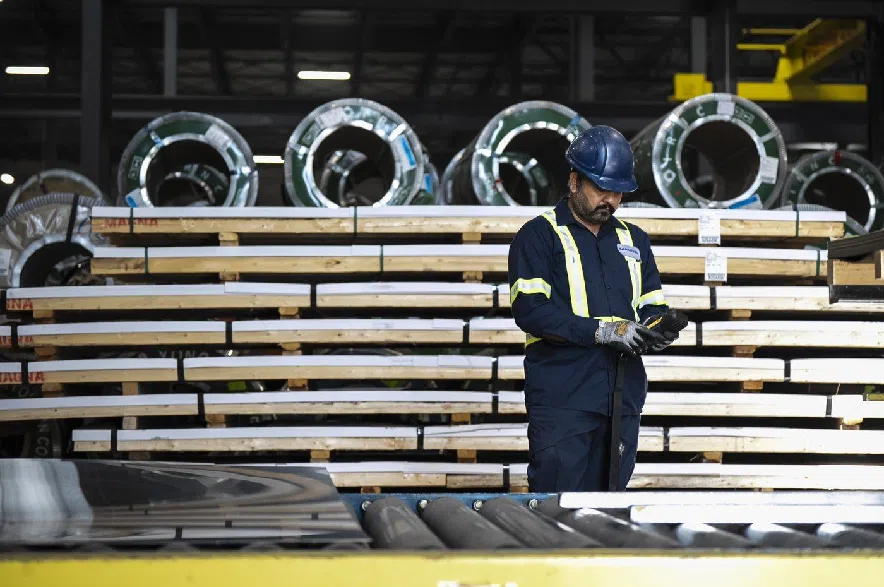 Workers inspect sheets of stainless steel after being pressed from coils, at Magna Stainless and Aluminum in Montreal on Thursday, Sept. 18, 2025.