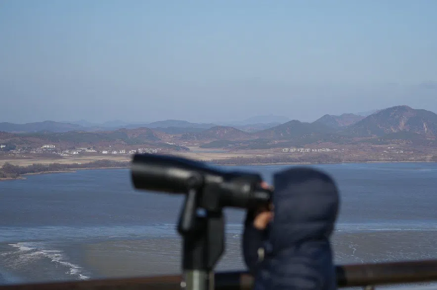 A visitor watches North Korean side from the unification observatory in Paju, South Korea, on Dec. 25, 2025.