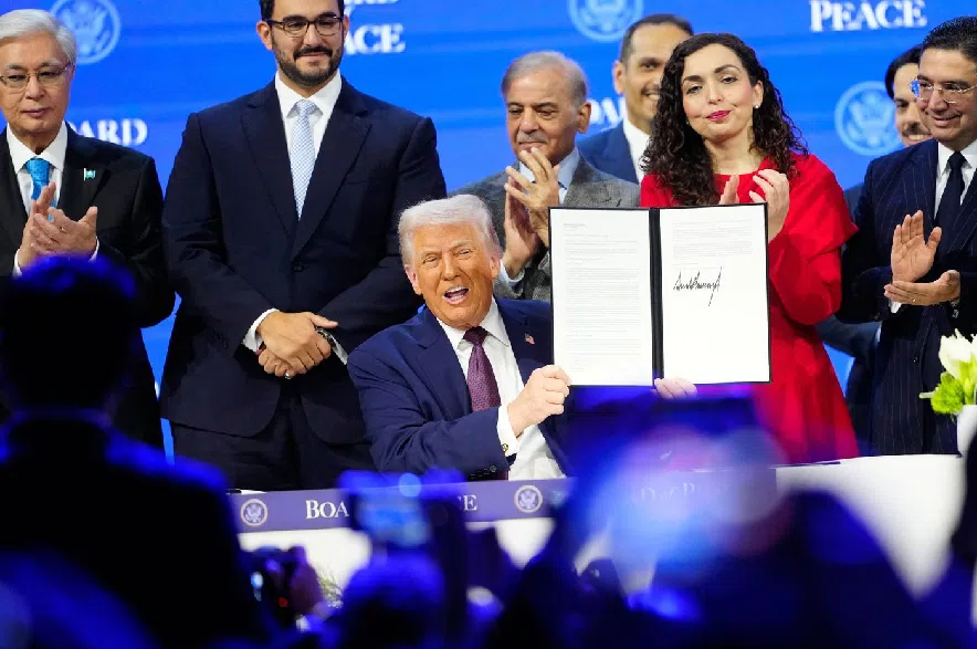 President Donald Trump holds the charter during a signing ceremony on his Board of Peace initiative at the Annual Meeting of the World Economic Forum in Davos, Switzerland, Thursday, Jan. 22, 2026.