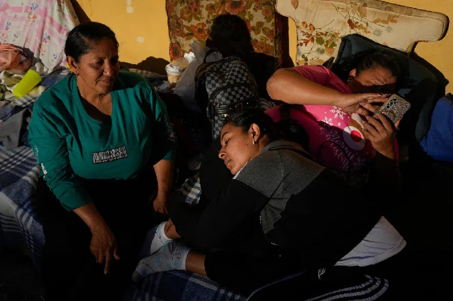 Mileidy Mendoza, center, waits at Zone 7 of the Bolivarian National Police, where her fiancé Eric Diaz is being held as a political detainee in Caracas, Venezuela, Sunday, Jan. 11, 2026, after the government announced prisoners would be released.