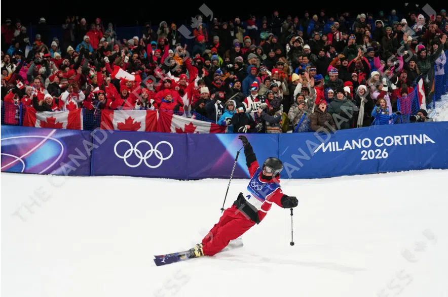 Brendan Mackay celebrates winning bronze in men's freestyle skiing halfpipe finals in Livigno, Italy on Friday, Feb. 20, 2026.