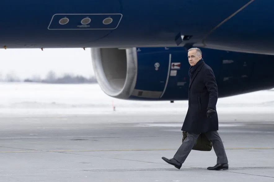 Prime Minister Mark Carney boards a government plane in Ottawa on Monday, Jan. 5, 2026.
