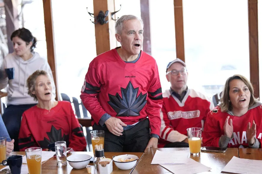 Prime Minister Mark Carney watching Olympic hockey.