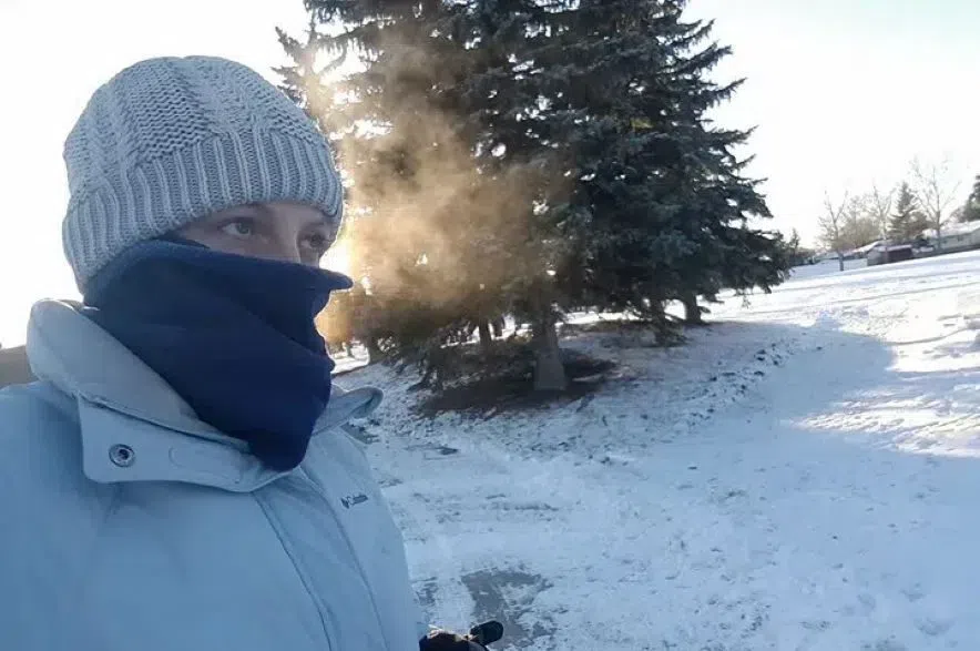 A person wearing a toque and neck warmer on a cold day in Saskatchewan.