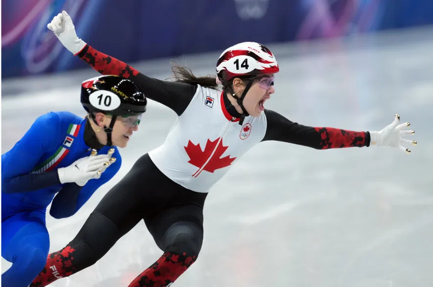 Canada's Courtney Sarault celebrates a bronze finish as Italy's Arianna Fontana gets the silver during the women's 500 metre short track speedskating finals at the 2026 Winter Olympics, in Milan, on Thursday, February 12, 2026.