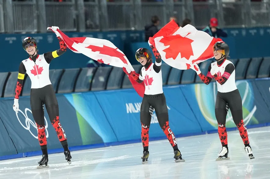 Canada's Ivanie Blondin, white armband, Valerie Maltais, red armband, Isabelle Weidemann, yellow armband, celebrate after winning the gold final of the women's team pursuit speedskating race at the 2026 Winter Olympics, in Milan, Italy, Tuesday, Feb. 17, 2026.