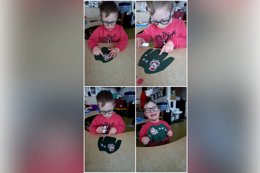 Eli Chevrier shows off a sweater craft he created.