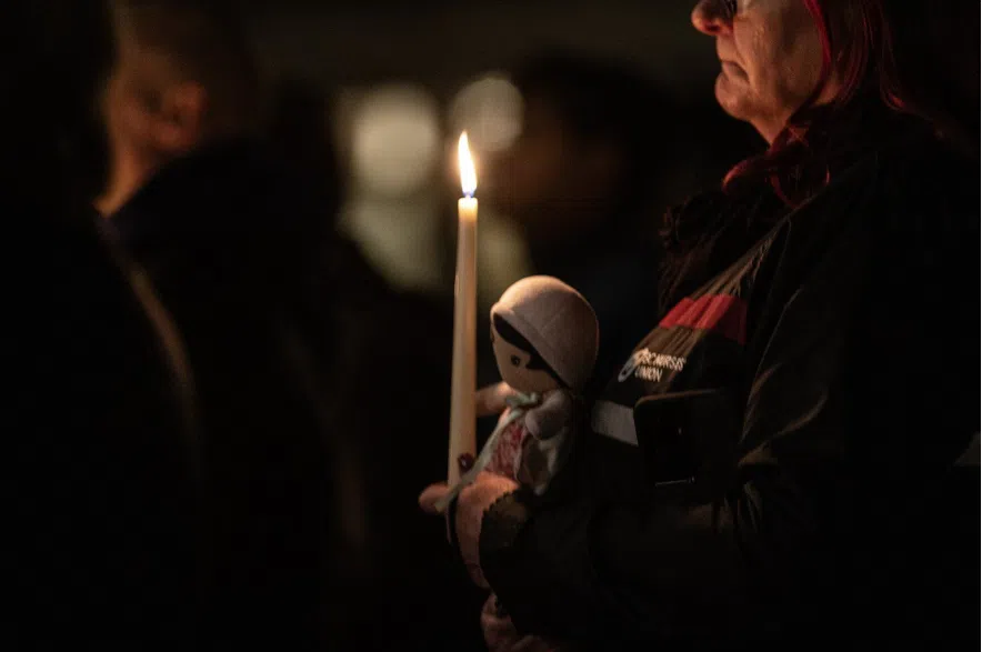 People attend a candle light vigil at the front steps of the legislature in Victoria, B.C., on Wednesday, Feb. 11, 2026 in honour of the victims of the school shooting in Tumbler Ridge, B.C.
