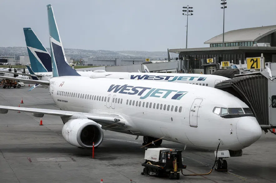WestJet passenger jets are shown parked at departure gates at the Calgary International Airport on Wednesday, May 31, 2023.